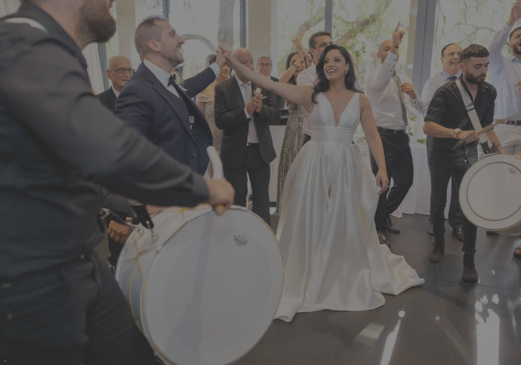 Wedding couple dancing with drummers in a celebratory setting