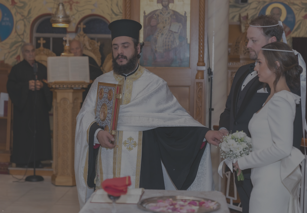 Ceremony in a church with a priest and a couple, surrounded by religious iconography.