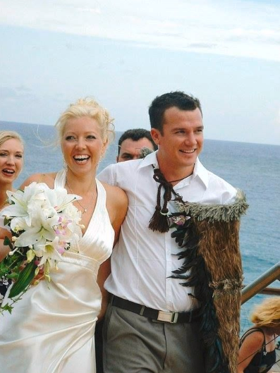 Wedding couple standing on a deck with ocean view