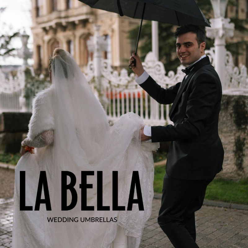 back of bride front groom under black umbrella in city image square