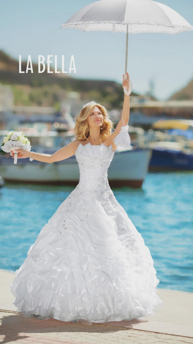 rippling water bride full body shot holding white frill umbrella overhead at harbour video portrait